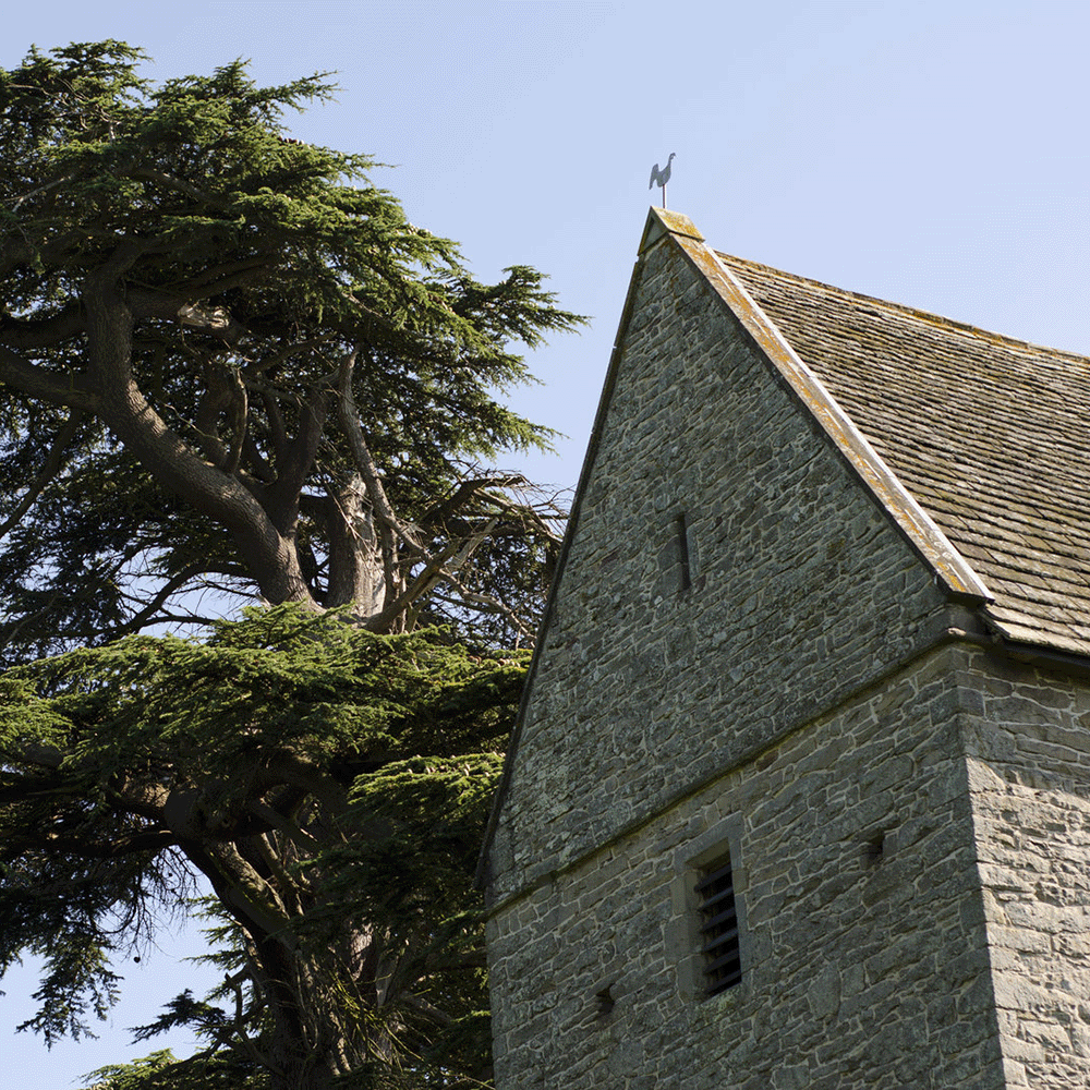 A stone church next to a tree